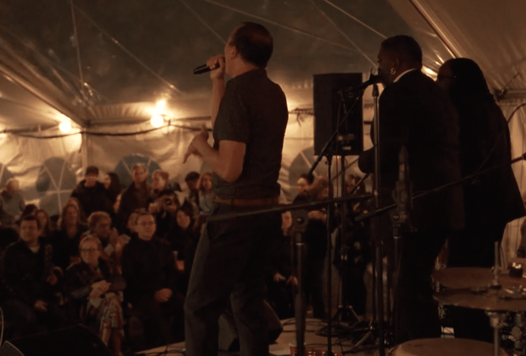 Men Singing in front of the crowd