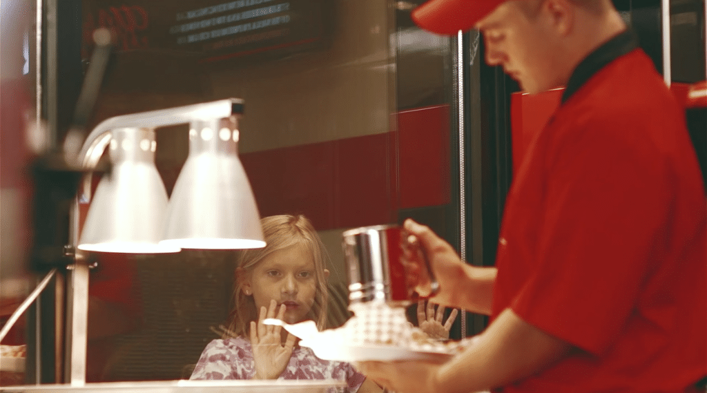 Little Girl Watching Person Making Food